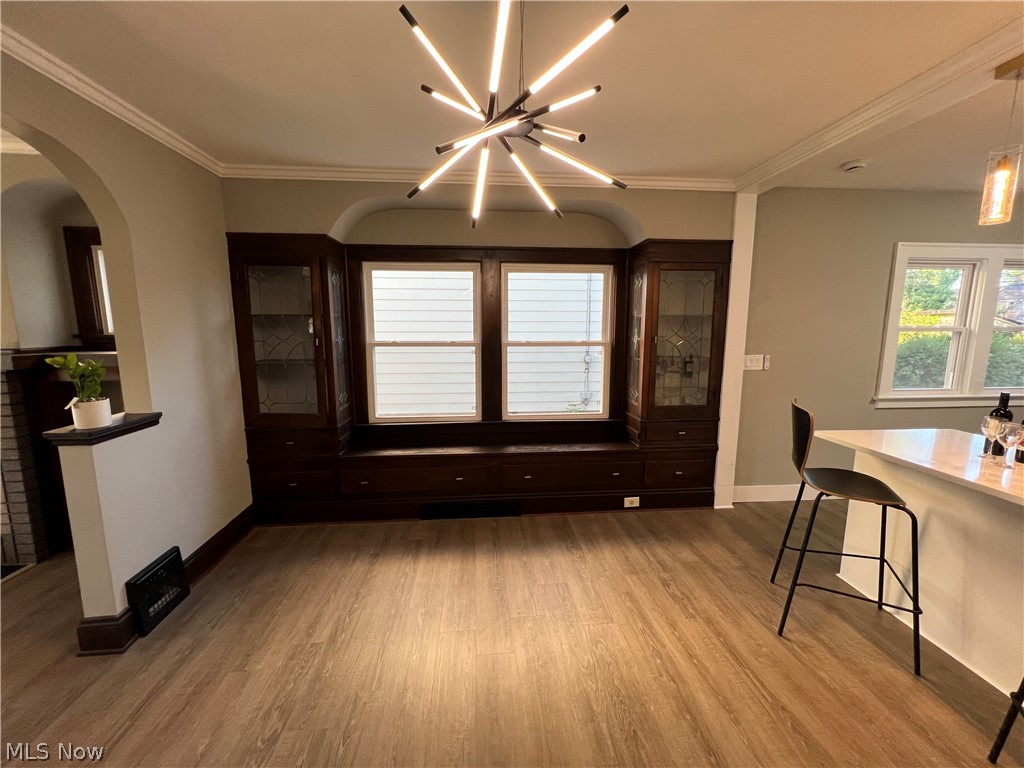 4523 Maplecrest Avenue Parma, OH 44134 - Photo 15 of 31 Dining room with wood-type flooring, ornamental molding, and an inviting chandelier