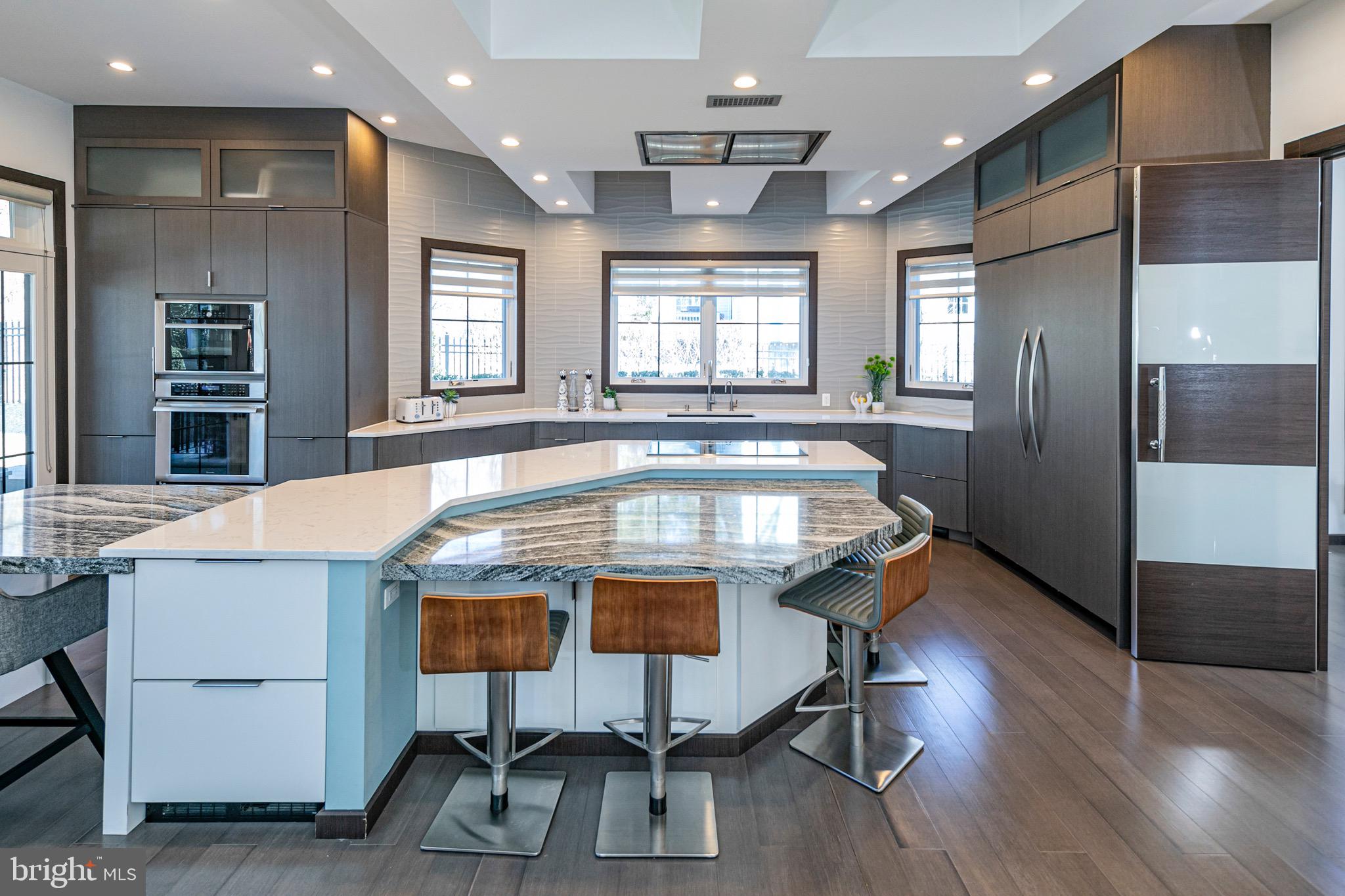 31 Westerly Road Princeton, NJ 08540 - Photo 15 of 47 a view of a kitchen with kitchen island stainless steel appliances wooden floor dining table and chairs
