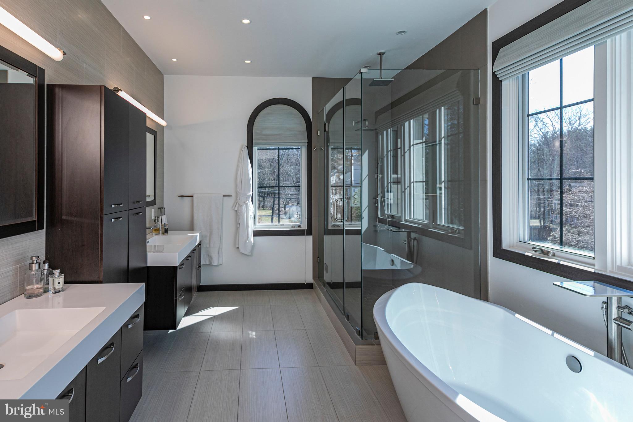 31 Westerly Road Princeton, NJ 08540 - Photo 28 of 47 a bathroom with a double vanity sink a mirror and a bathtub