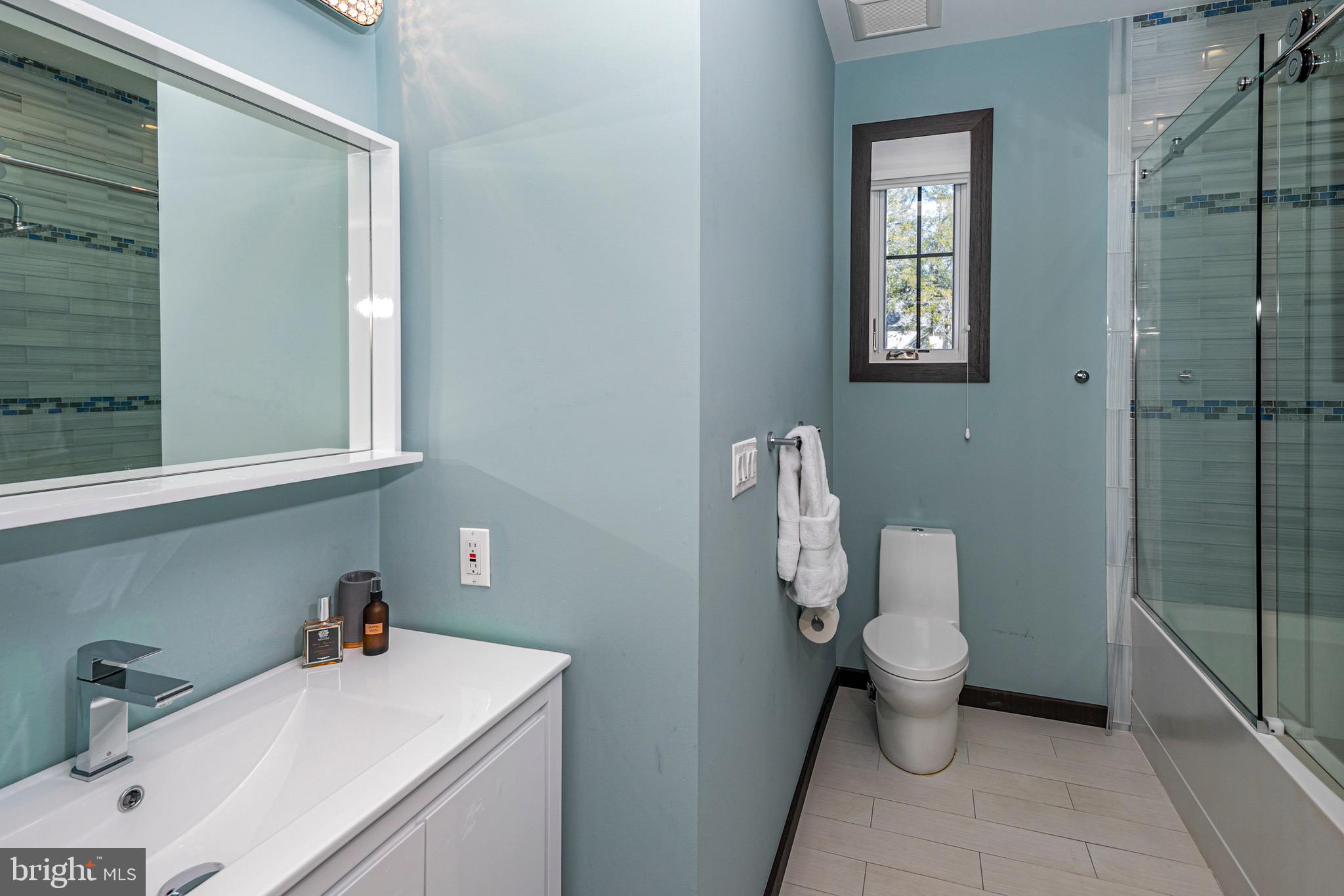 31 Westerly Road Princeton, NJ 08540 - Photo 35 of 47 a bathroom with a sink mirror and toilet