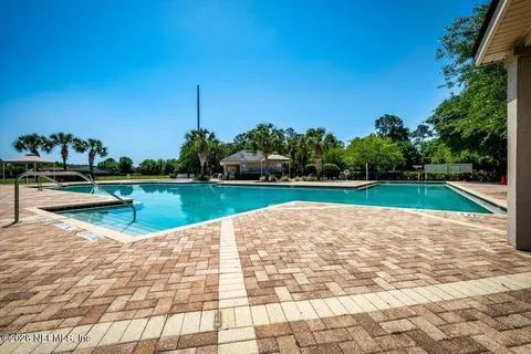a view of a swimming pool with a yard