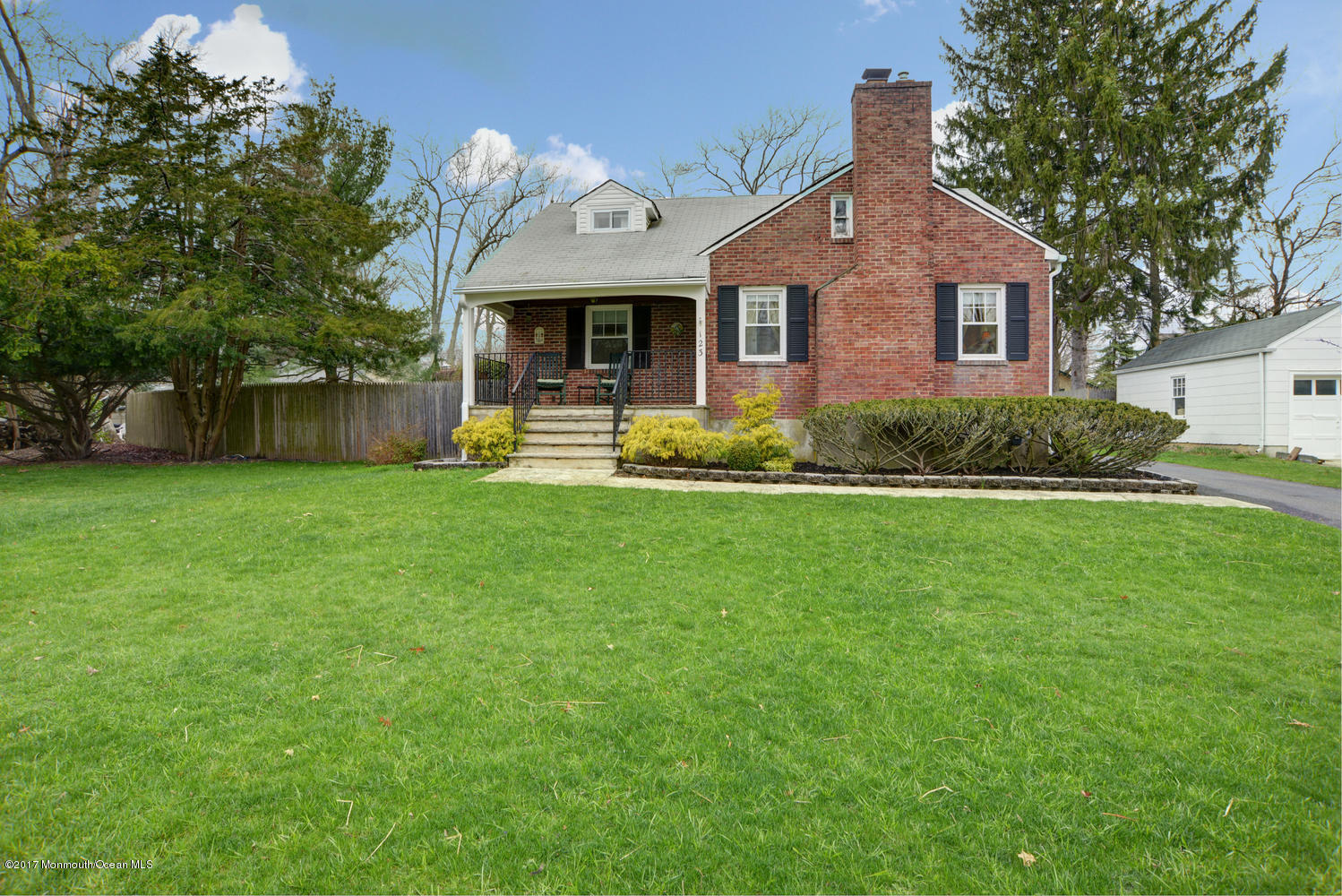 123 Robin Road Neptune Township, NJ 07753 - Photo 2 of 28 a front view of a house with a yard and garage