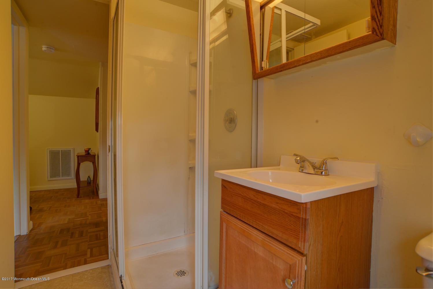 123 Robin Road Neptune Township, NJ 07753 - Photo 20 of 28 a bathroom with a sink a toilet and shower