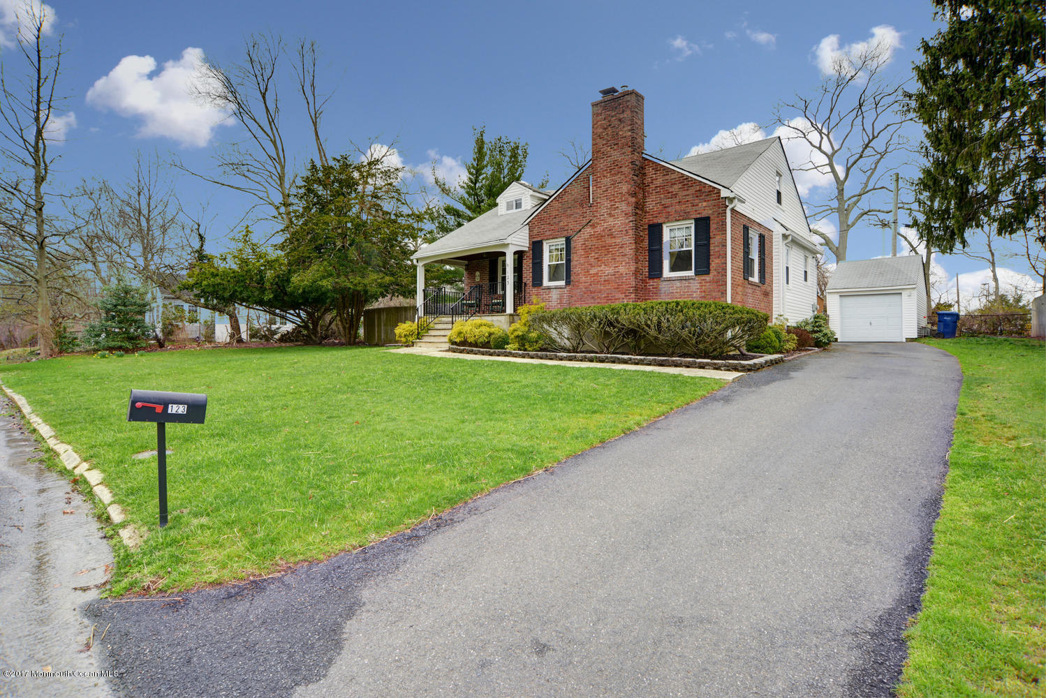 123 Robin Road Neptune Township, NJ 07753 - Photo 3 of 28 a front view of a house with a yard and garage