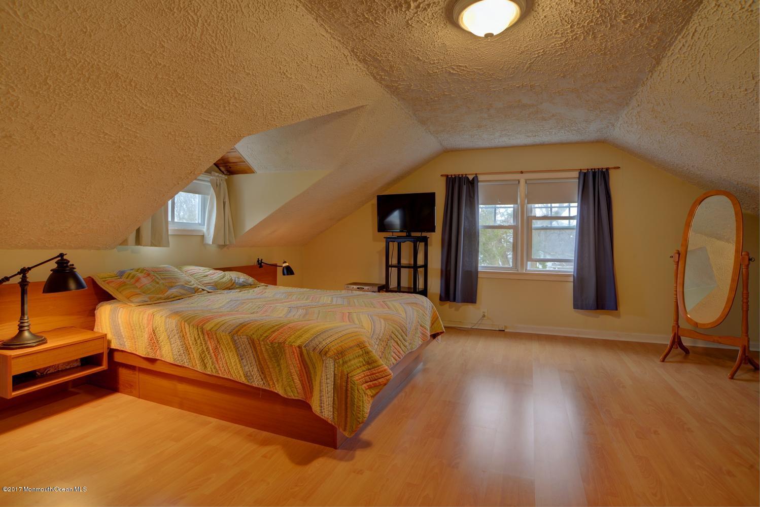 123 Robin Road Neptune Township, NJ 07753 - Photo 21 of 28 a spacious bedroom with a bed and wooden floor