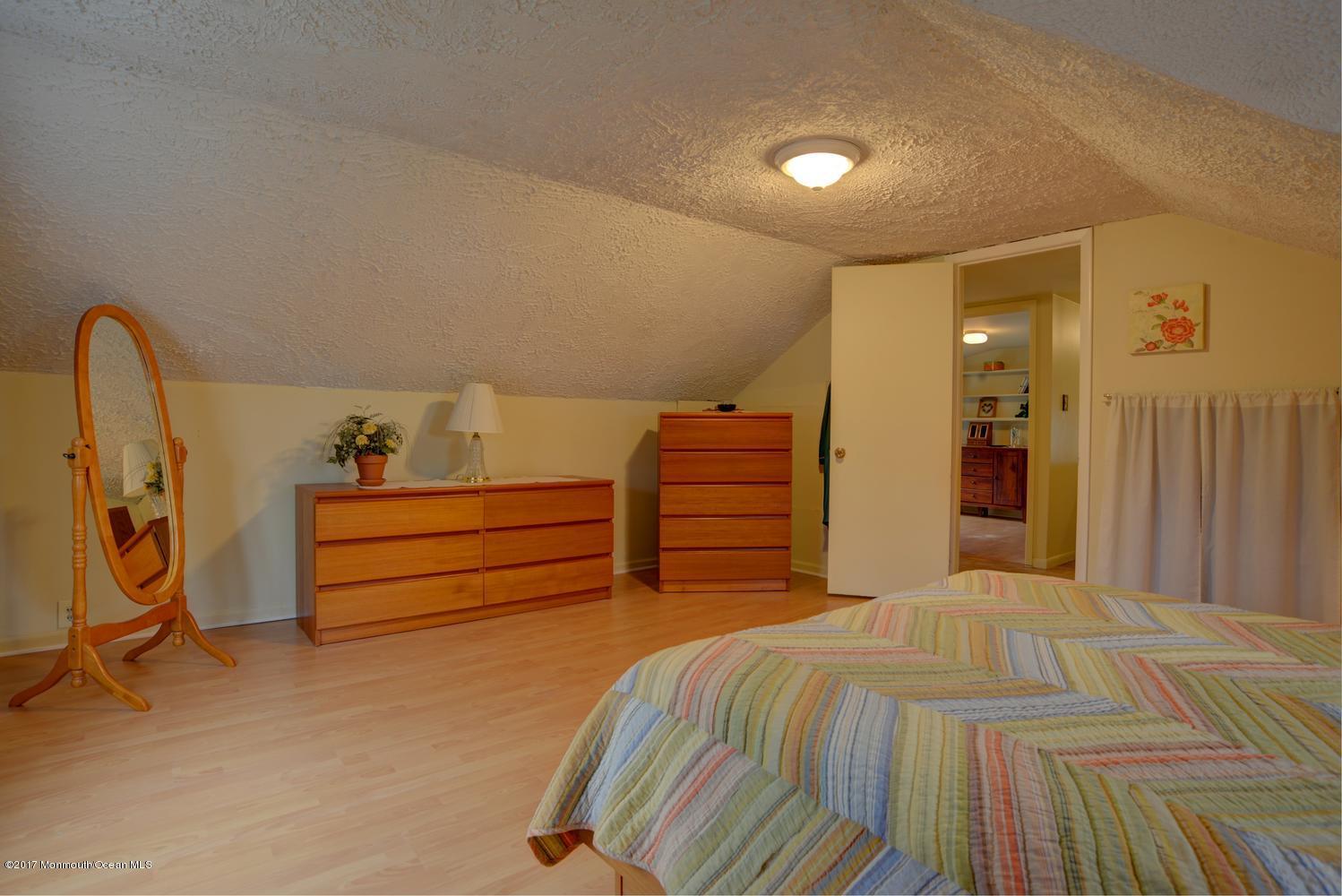 123 Robin Road Neptune Township, NJ 07753 - Photo 22 of 28 a bed room with a bed and a walk in closet