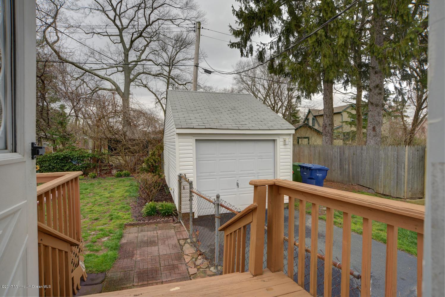 123 Robin Road Neptune Township, NJ 07753 - Photo 25 of 28 a view of a wooden house with a small yard and large tree