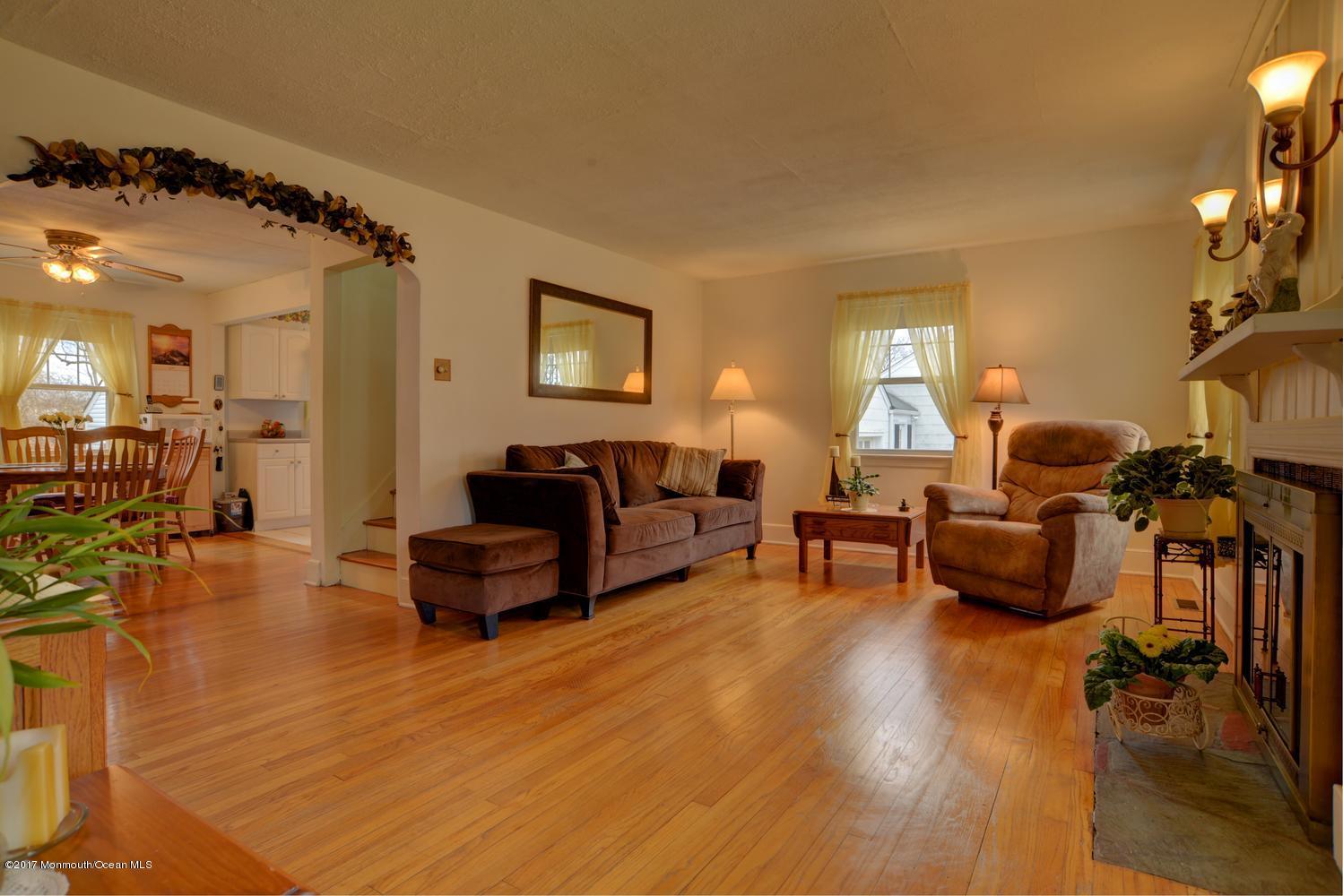 123 Robin Road Neptune Township, NJ 07753 - Photo 6 of 28 a living room with furniture and a wooden floor
