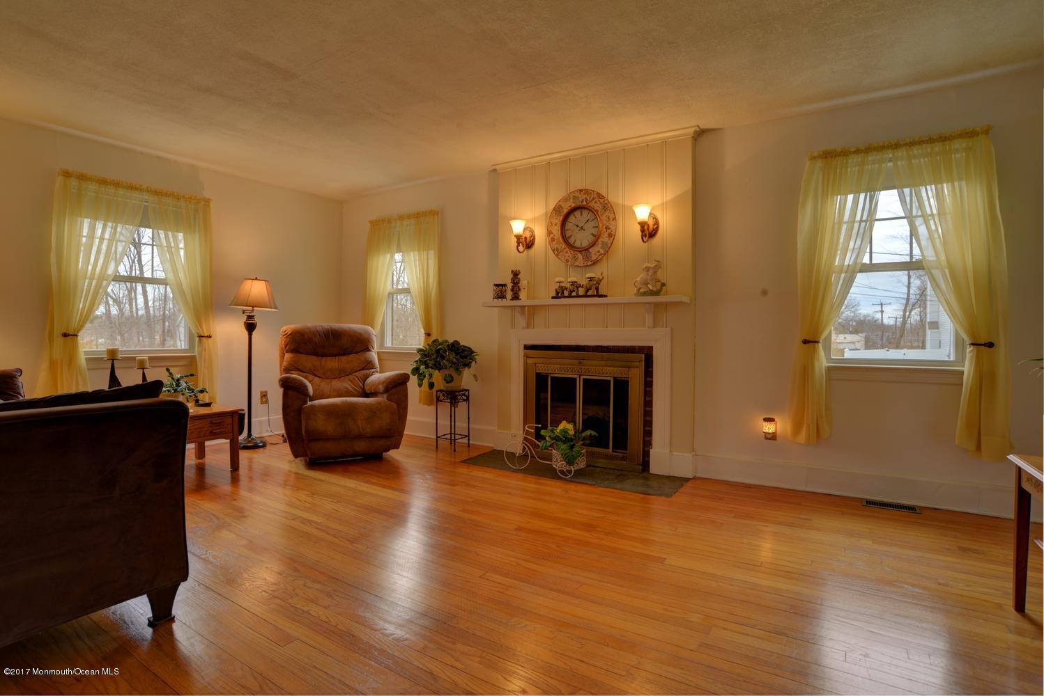 123 Robin Road Neptune Township, NJ 07753 - Photo 7 of 28 a living room with furniture and a fireplace
