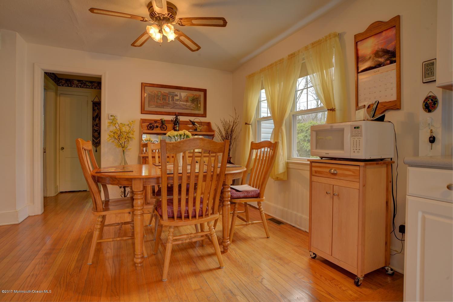 123 Robin Road Neptune Township, NJ 07753 - Photo 9 of 28 a dining room with furniture a chandelier and wooden floor
