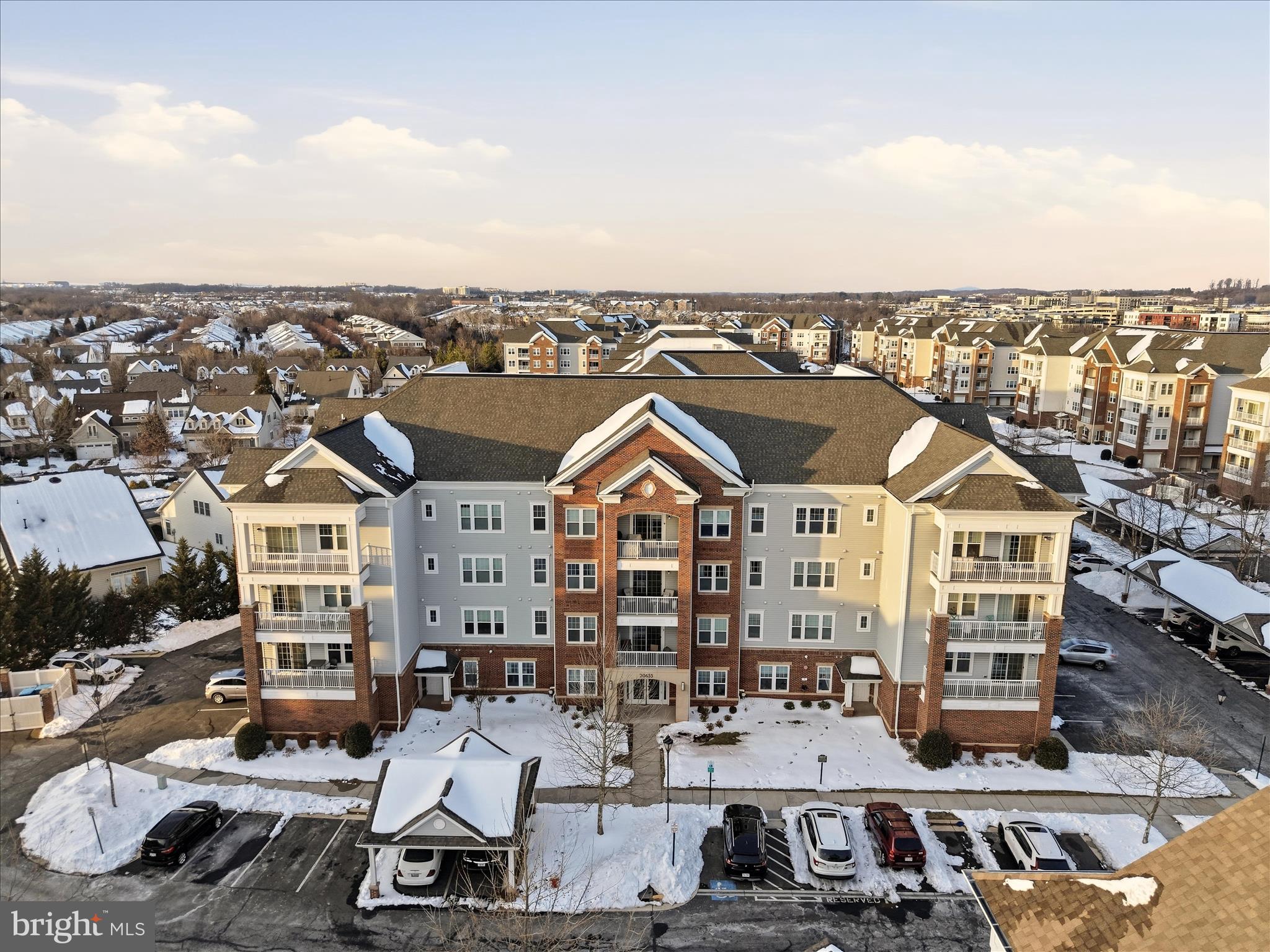 20655 Hope Spring Terrace, Unit 104 Ashburn, VA 20147 - Photo 2 of 40 an aerial view of a large building and couple of cars parked in front of it