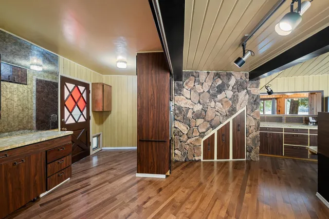 a view of empty room with wooden walls