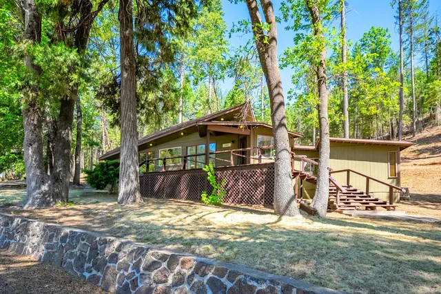 a porch with wooden floor in front of it