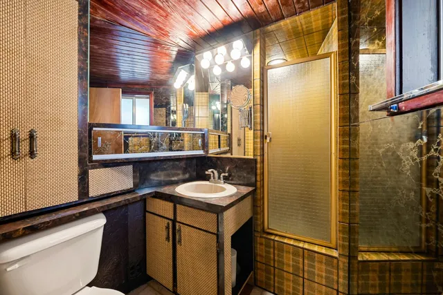 a view of an empty room with cabinet and a large window