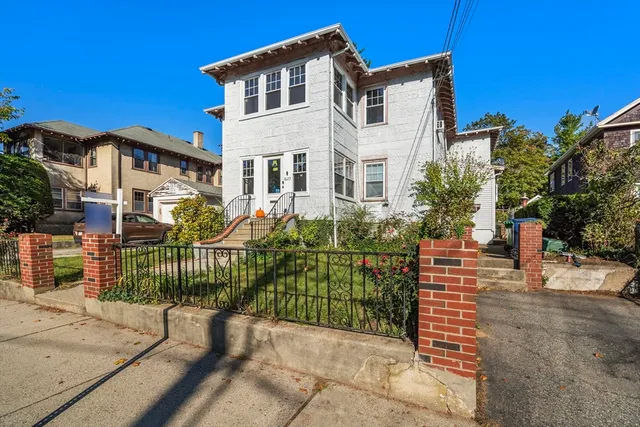 a front view of a house with a garden