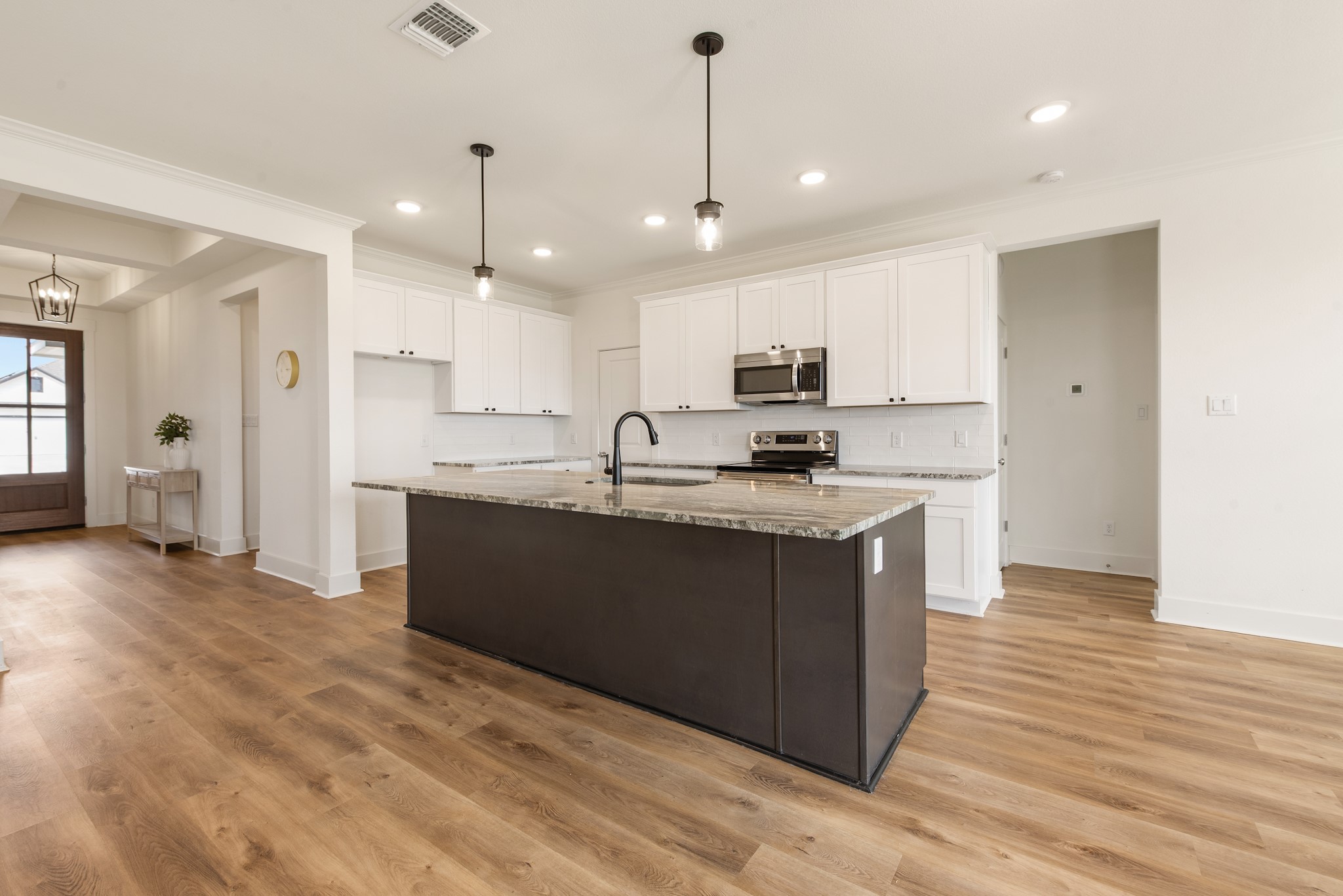 424 Brazos Bend Snook, TX 77879 - Photo 7 of 23 a kitchen with kitchen island granite countertop a sink a counter top space stainless steel appliances and cabinets