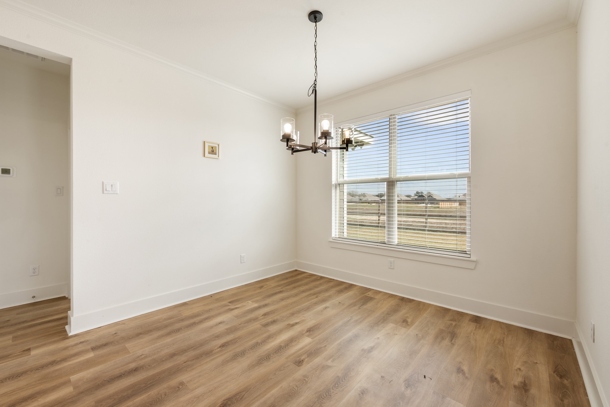 424 Brazos Bend Snook, TX 77879 - Photo 10 of 23 a view of an empty room with wooden floor and a window