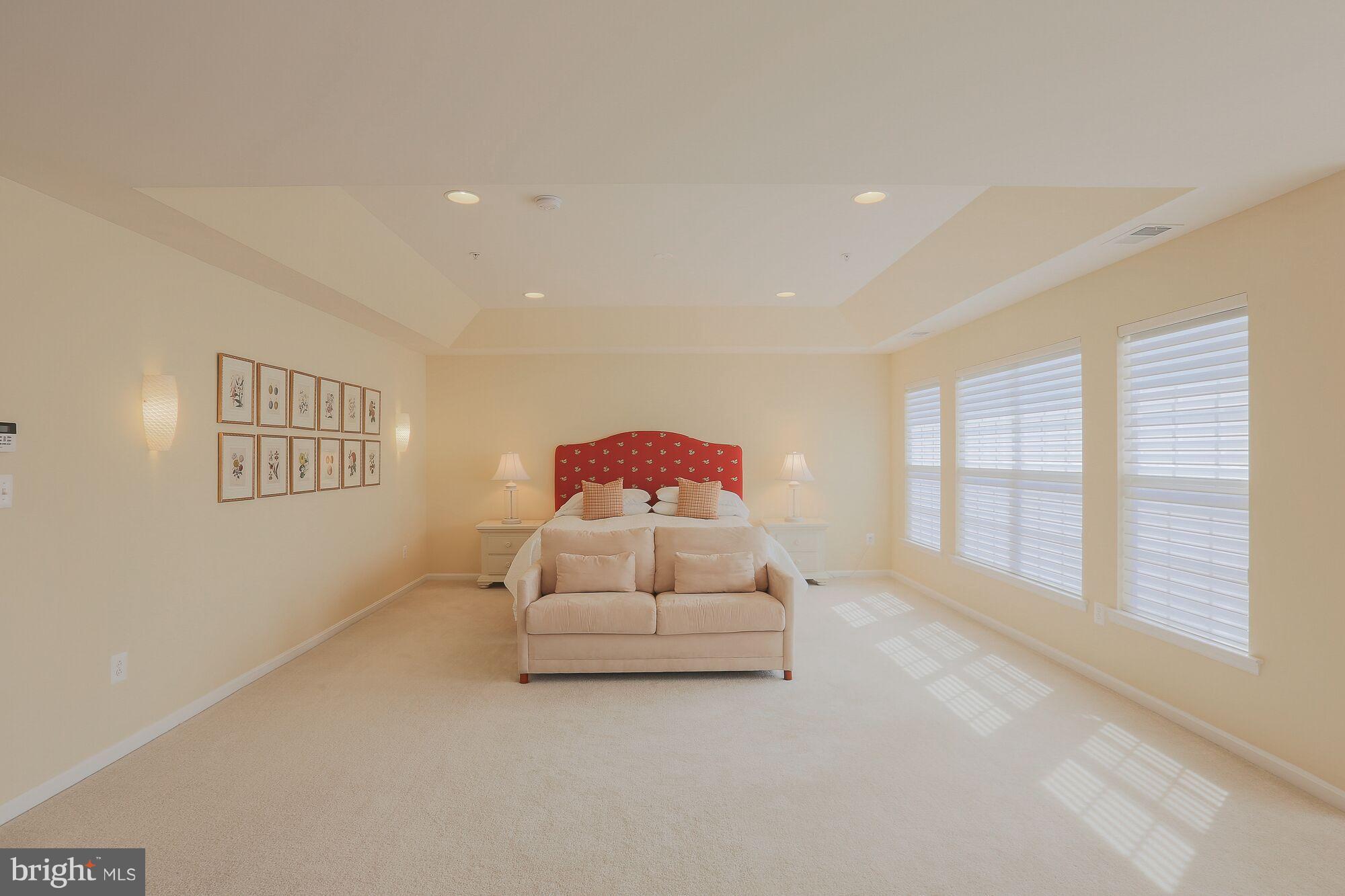 6524 Pebble Brooke Road Baltimore, MD 21209 - Photo 11 of 20 a spacious bedroom with a bed and a large window