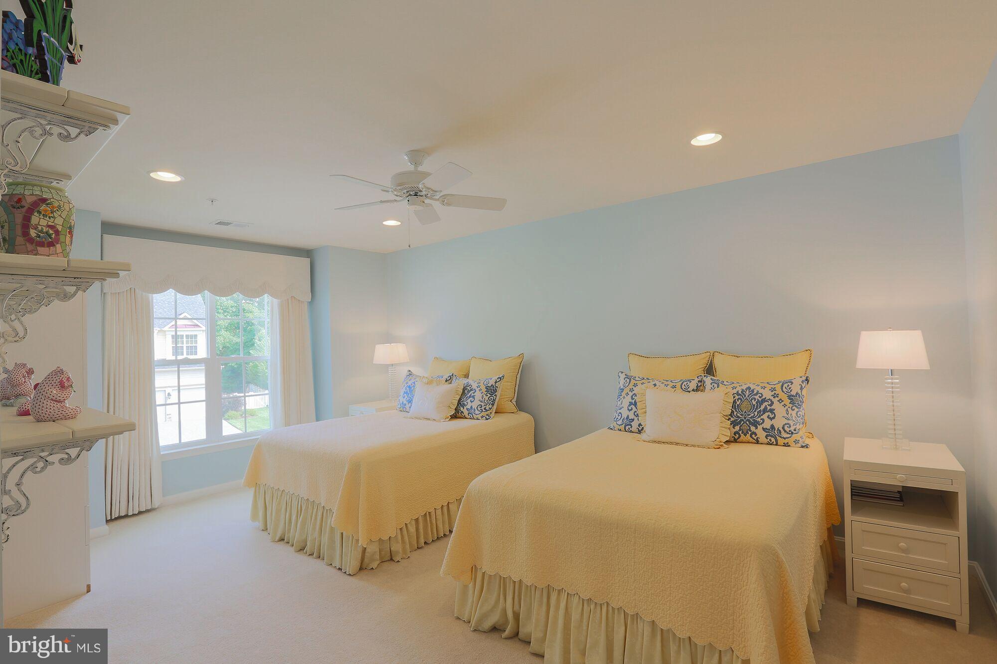 6524 Pebble Brooke Road Baltimore, MD 21209 - Photo 15 of 20 a bedroom with two beds and a chandelier