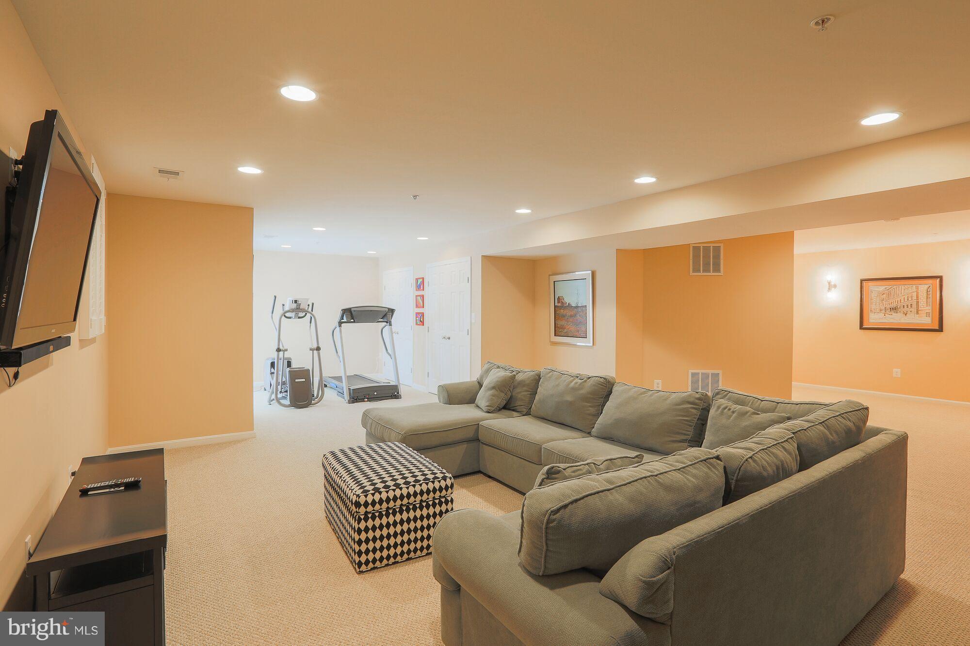 6524 Pebble Brooke Road Baltimore, MD 21209 - Photo 19 of 20 a living room with furniture and a flat screen tv