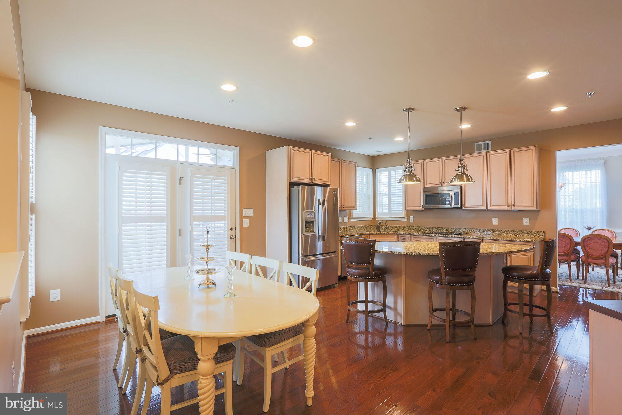 6524 Pebble Brooke Road Baltimore, MD 21209 - Photo 8 of 20 a large kitchen with a table and chairs