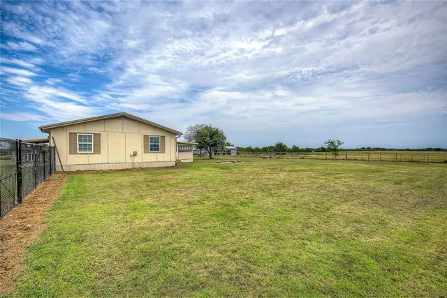 a view of a big room with yard and garage