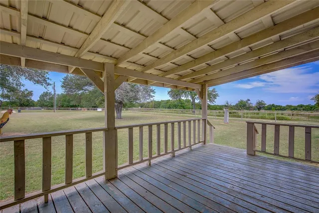 a view of a balcony with wooden floor