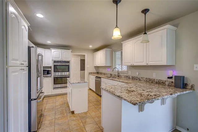 a kitchen with refrigerator and cabinets