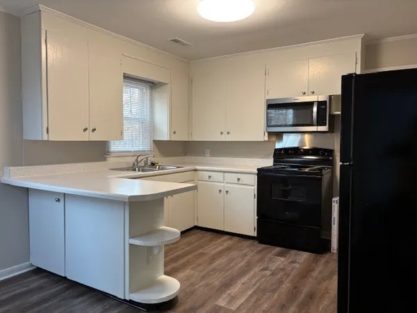 a kitchen with a sink cabinets and stainless steel appliances