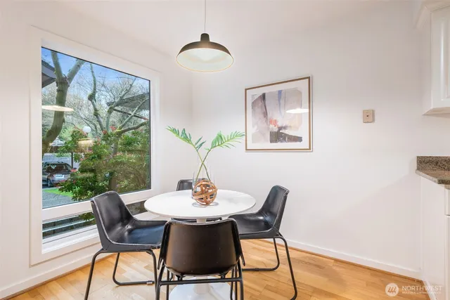 a dining room with furniture and wooden floor