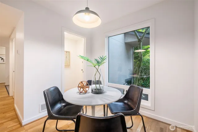 a view of a dining room with furniture window and wooden floor