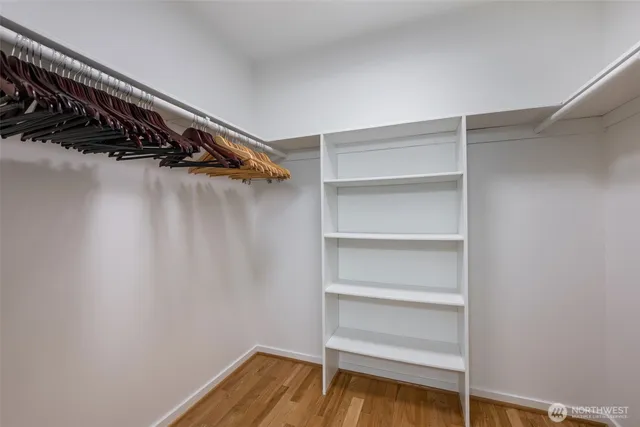 a view of walk in closet with empty racks