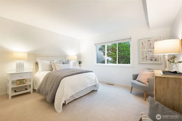 a bedroom with a bed and a window