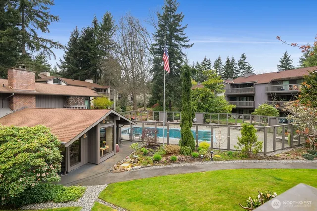 a view of a house with a yard balcony and sitting area