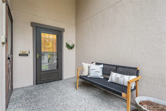 a view of a entrance door of house and car parked