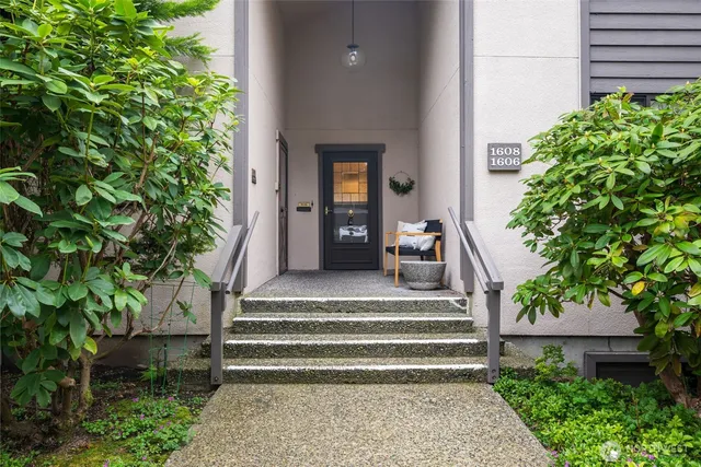 a front view of a house with plants and a yard