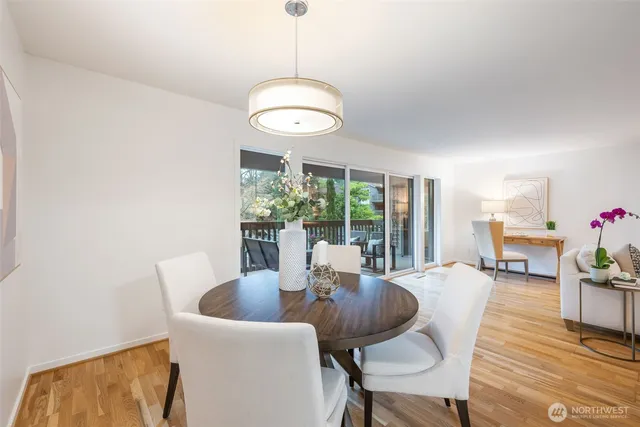 a view of a dining room with furniture wooden floor and chandelier