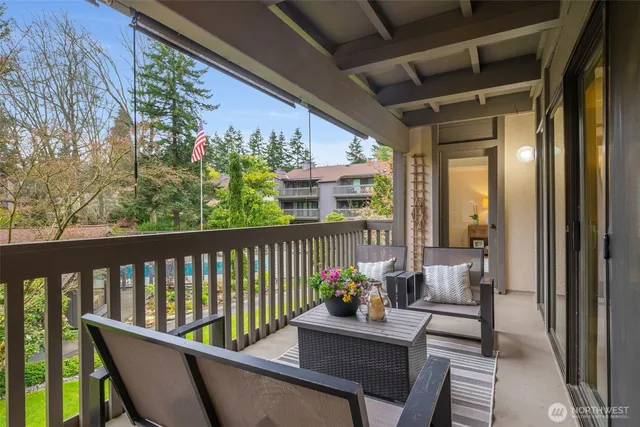 a view of a two chairs in the balcony