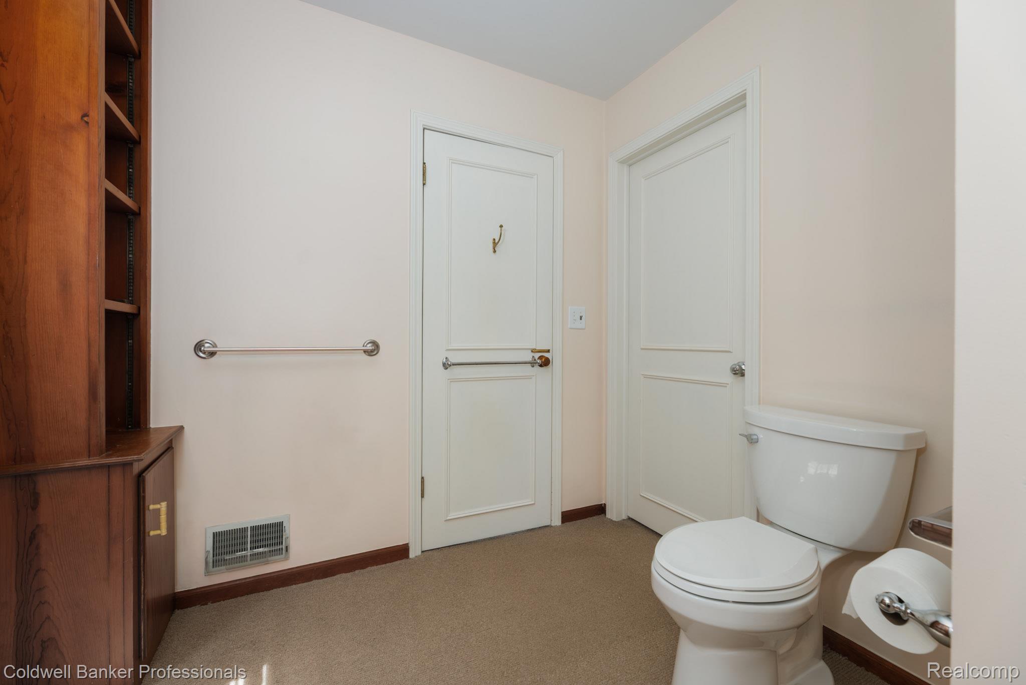 1018 Harvard Road Grosse Pointe, MI 48230 - Photo 21 of 40 Neutral-toned wall paint complements the wood-finish built-in cabinetry with open shelving and closed storage