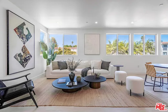 a living room with furniture and painting on the wall