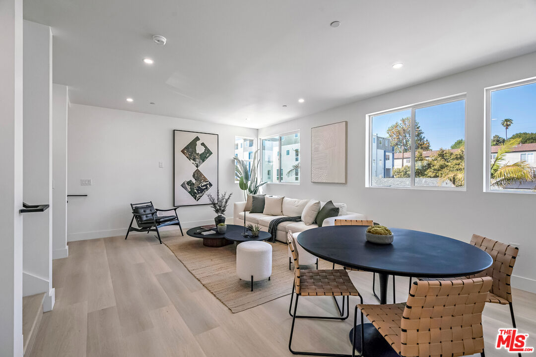 5832 David Avenue, Unit 1 Los Angeles, CA 90034 - Photo 18 of 44 a living room with furniture a rug and a table