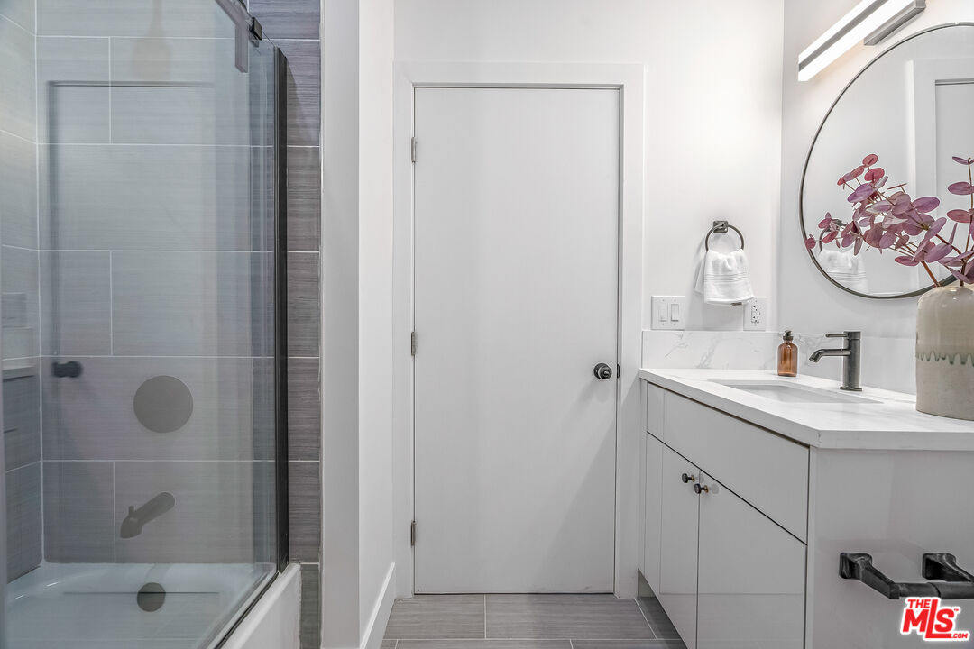 5832 David Avenue, Unit 1 Los Angeles, CA 90034 - Photo 31 of 44 a bathroom with a shower and a sink