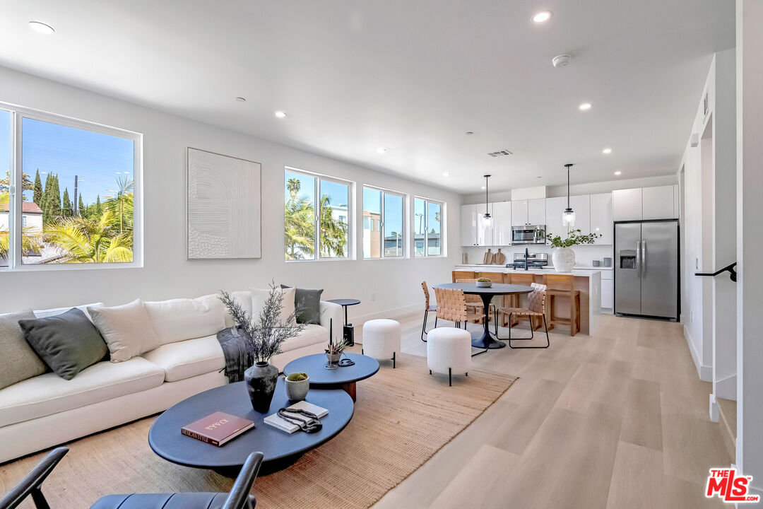 5832 David Avenue, Unit 1 Los Angeles, CA 90034 - Photo 9 of 44 a living room with furniture and a dining table with kitchen view