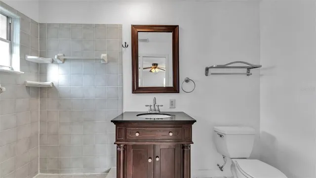 a bathroom with a toilet sink and mirror