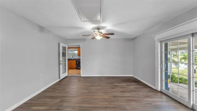 wooden floor in an empty room with a window