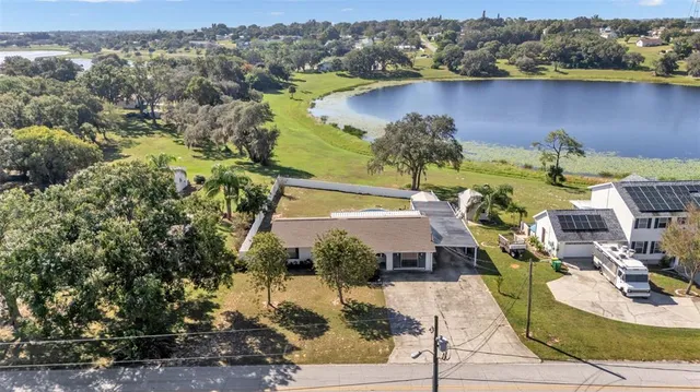 an aerial view of a house with a yard