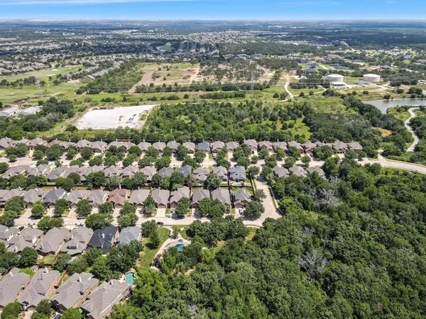 an aerial view of residential houses with city view
