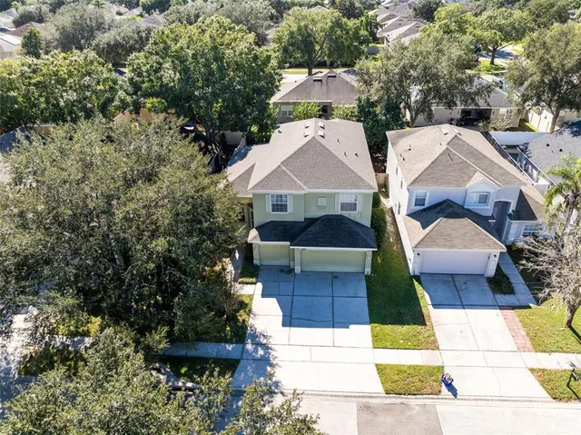 a view of house with garden space and sitting area