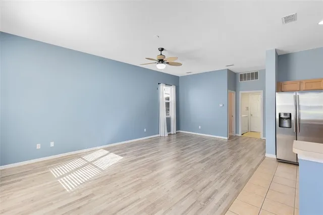 a view of a kitchen with a sink and a refrigerator