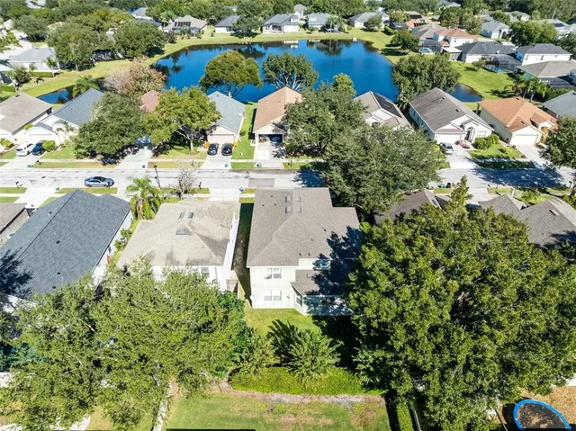 an aerial view of residential houses with outdoor space and swimming pool